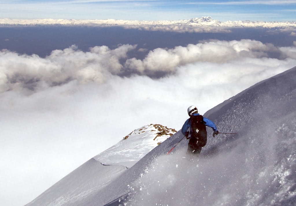An expert skier carves down a steep mountainside in Gulmarg