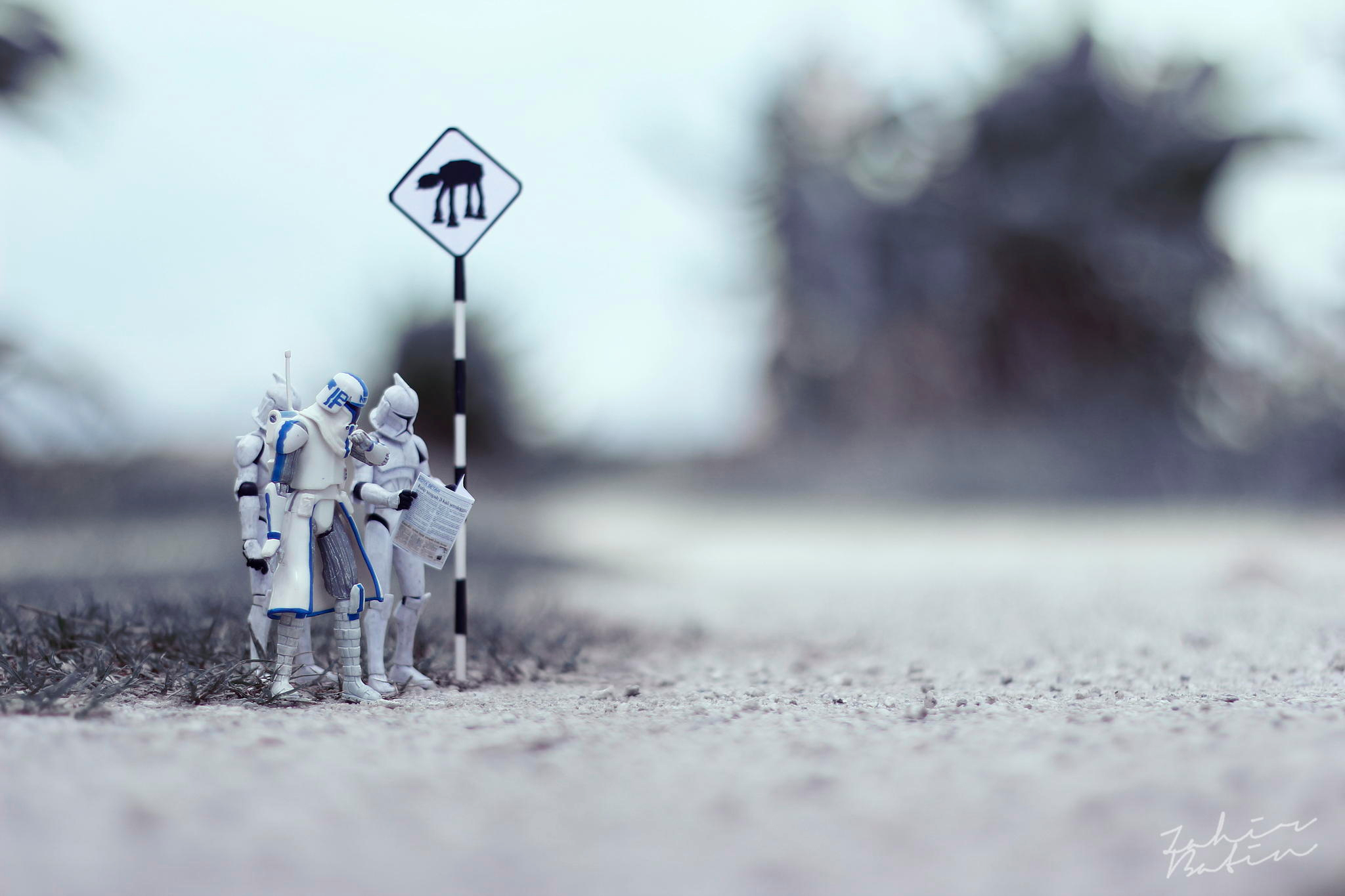 A photo by Zahir Batin shows 3 Stormtrooper figurines consulting a map before crossing the street