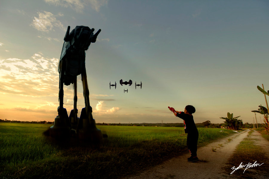 A fleet of Star Wars spaceships fly towards a little boy on a country dirt road