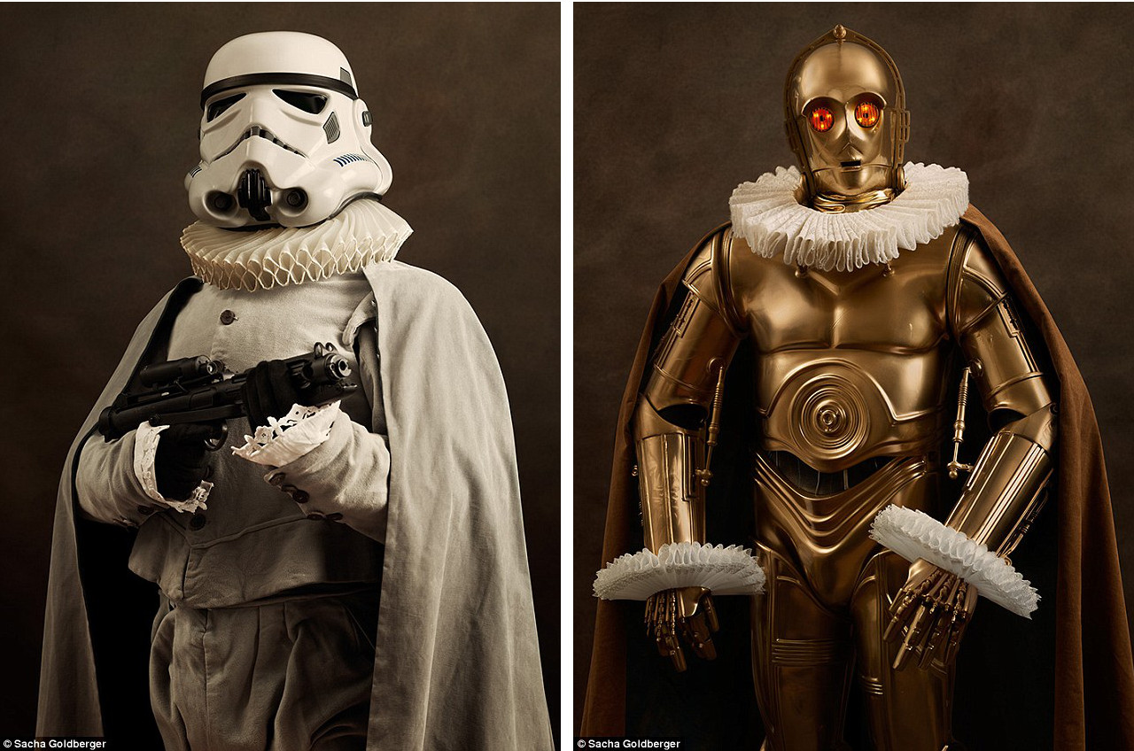 A C-3PO and a Stormtrooper, respectively, are dressed in Shakespearean collars and capes