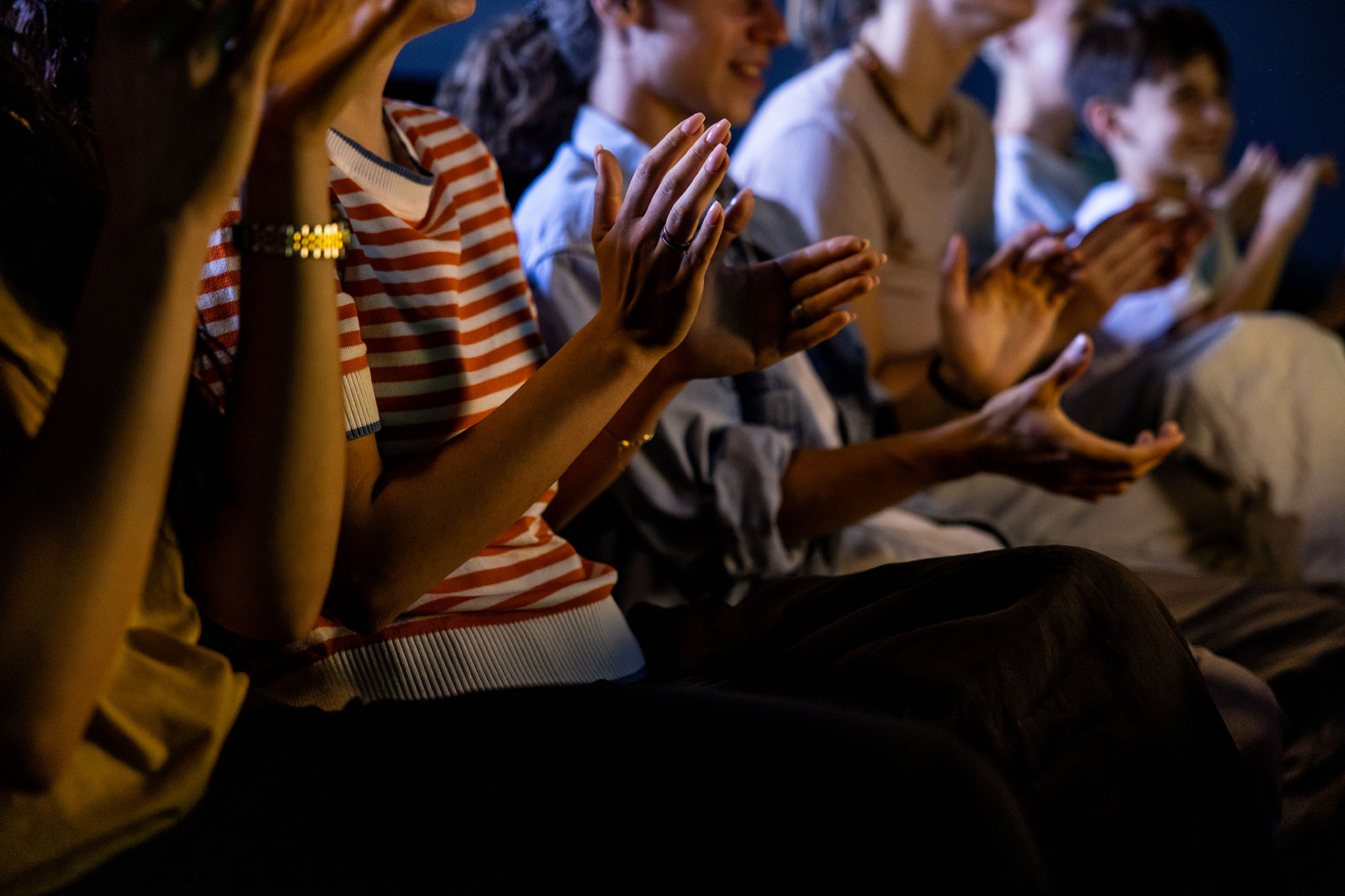 Smiling audience applauding